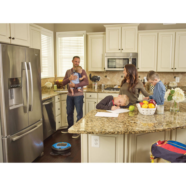 Robotic vacuum near family in kitchen