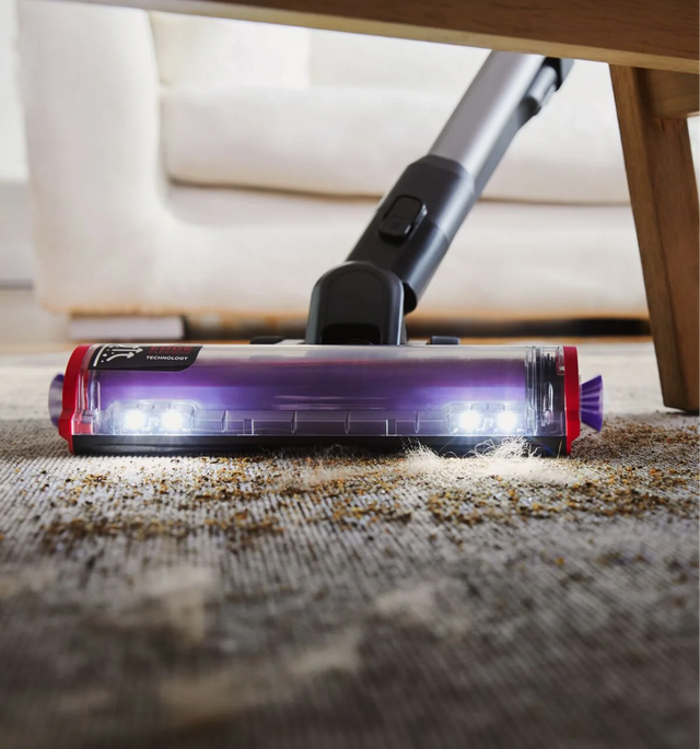 Summit Series stick vacuum under a coffee table