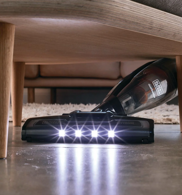 BLACK+DECKER vacuum with 4 bright LED lights under a coffee table