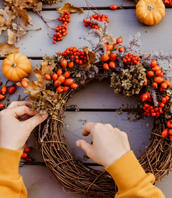 person making a wreath