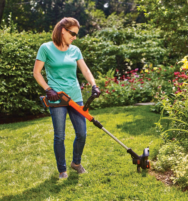 Woman using BLACK+DECKER string trimmer