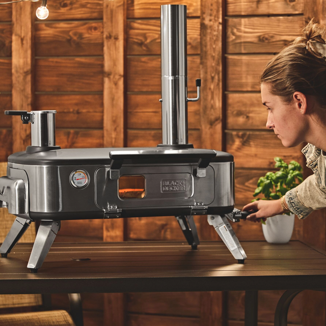 woman using rotating cook feature of vera pizza oven