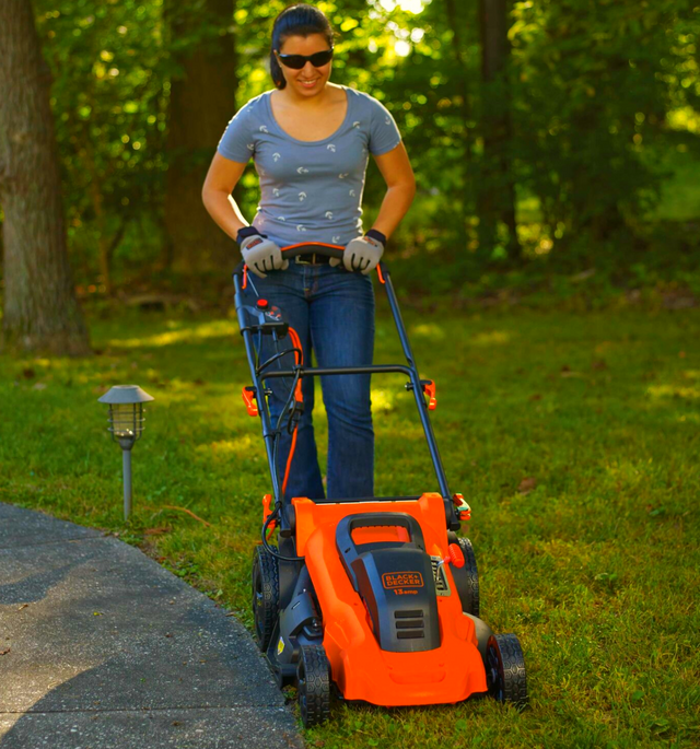 Woman pushing BLACK+DECKER electric lawn mower