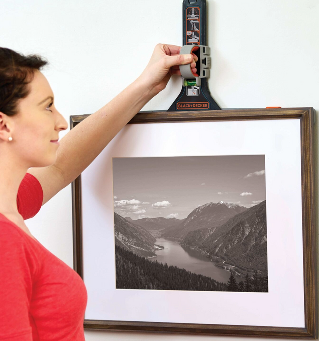 BLACK+DECKER markit picture hanger being used by a woman