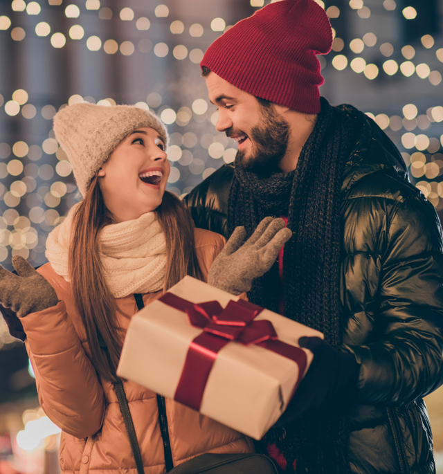 woman receiving a gift outdoors