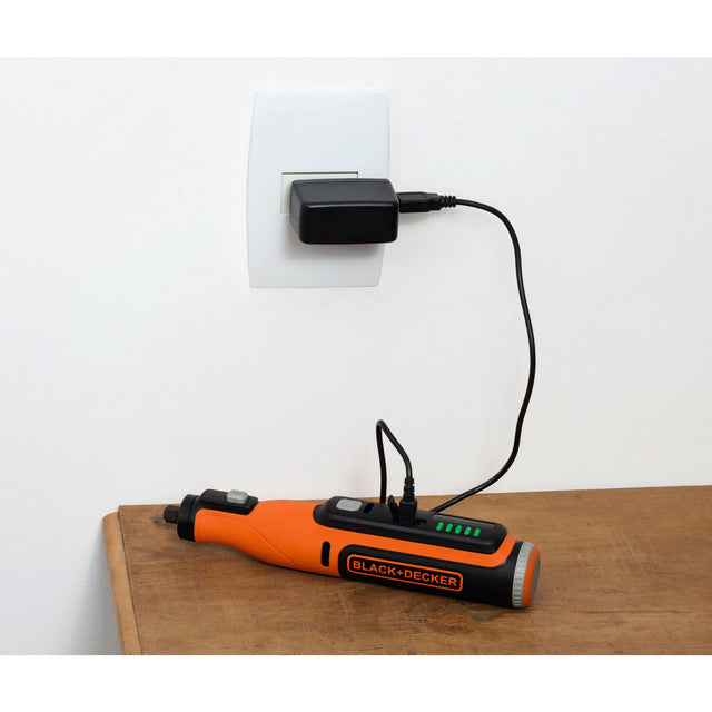 8 volt max cordless rotary tool with 35 piece accessory set  plugged into wall being charged.